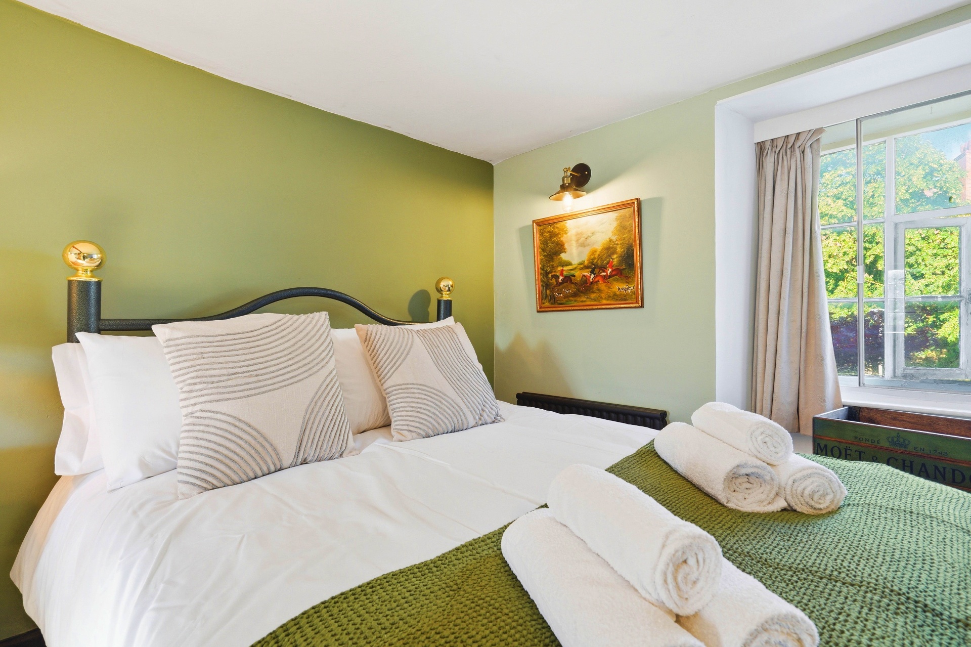 Bedroom Two double bed with iron headboard and brass finials