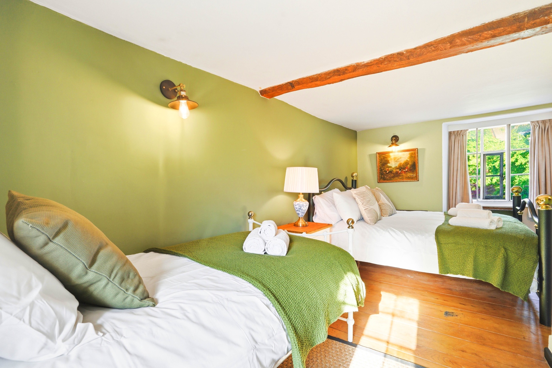 Bedroom Two showing both the double and single beds with an exposed oak beam