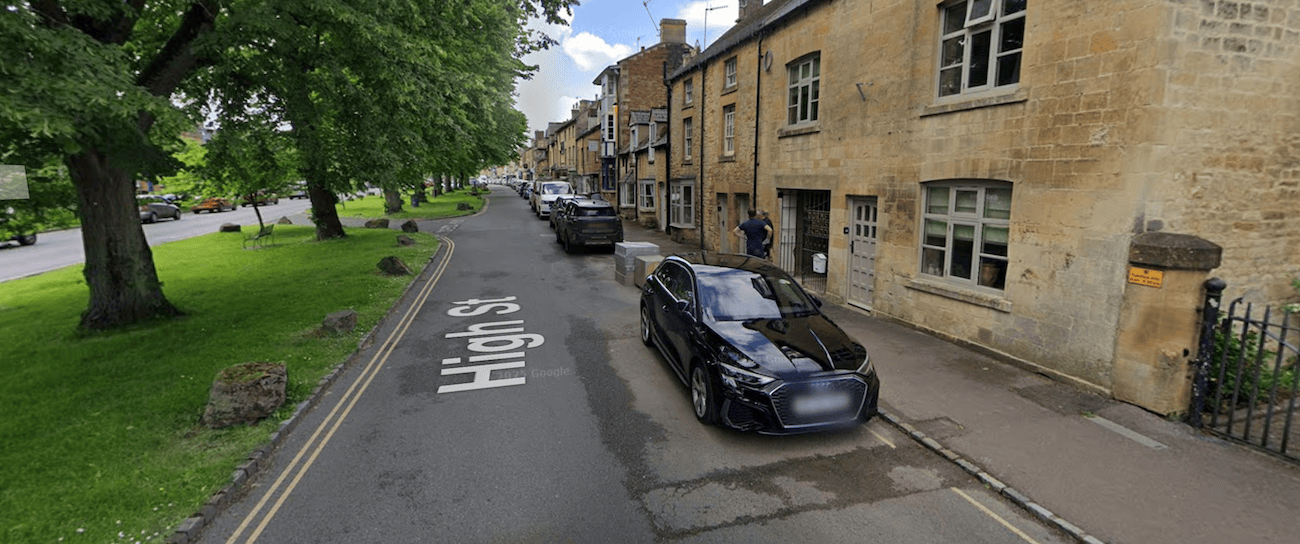 Marked parking bays beside the cottages on the High Street.