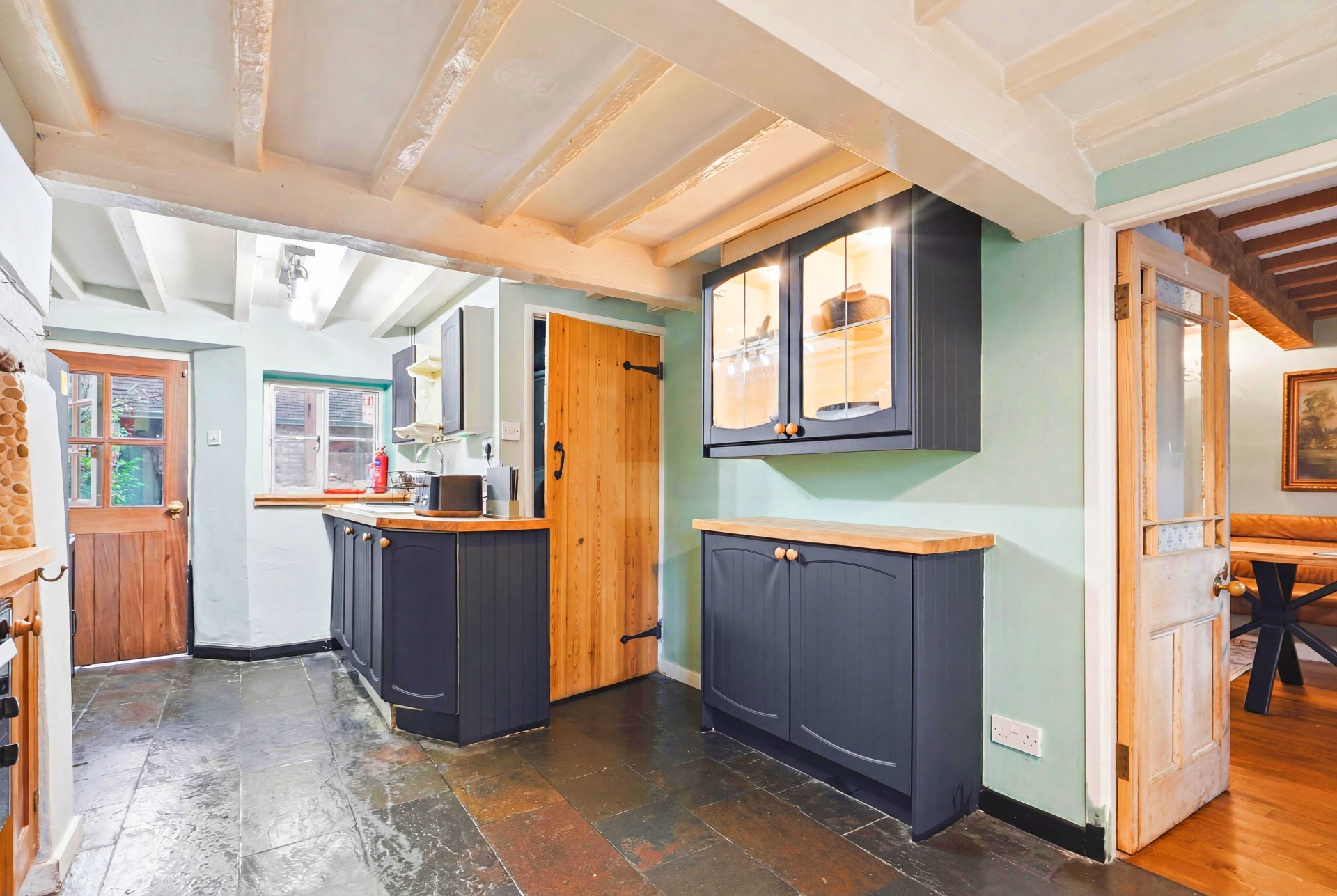 Wide view of the farmhouse kitchen with original beams and slate floor