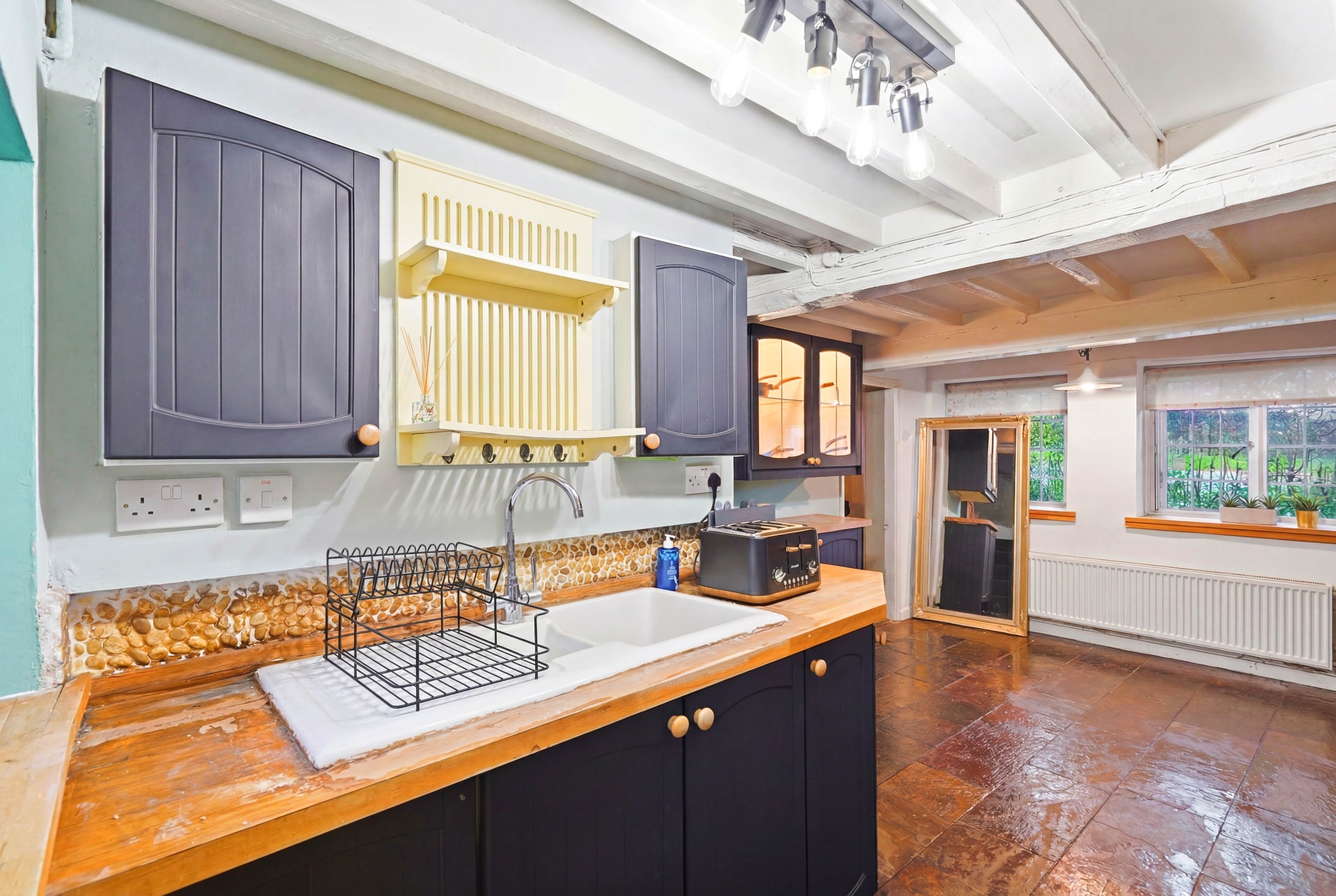 Kitchen sink area with toaster and worktops
