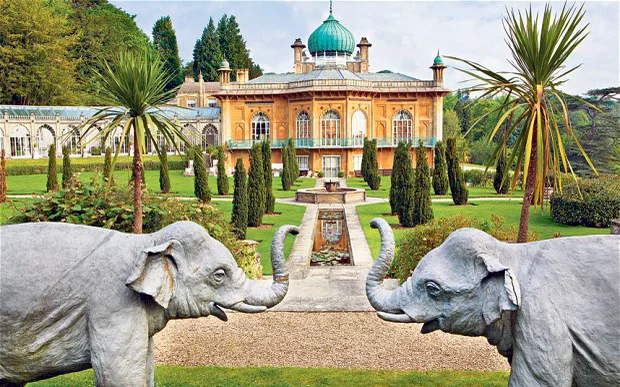 The stone elephant fountain in the south garden at Sezincote, with palms and the pavilion behind