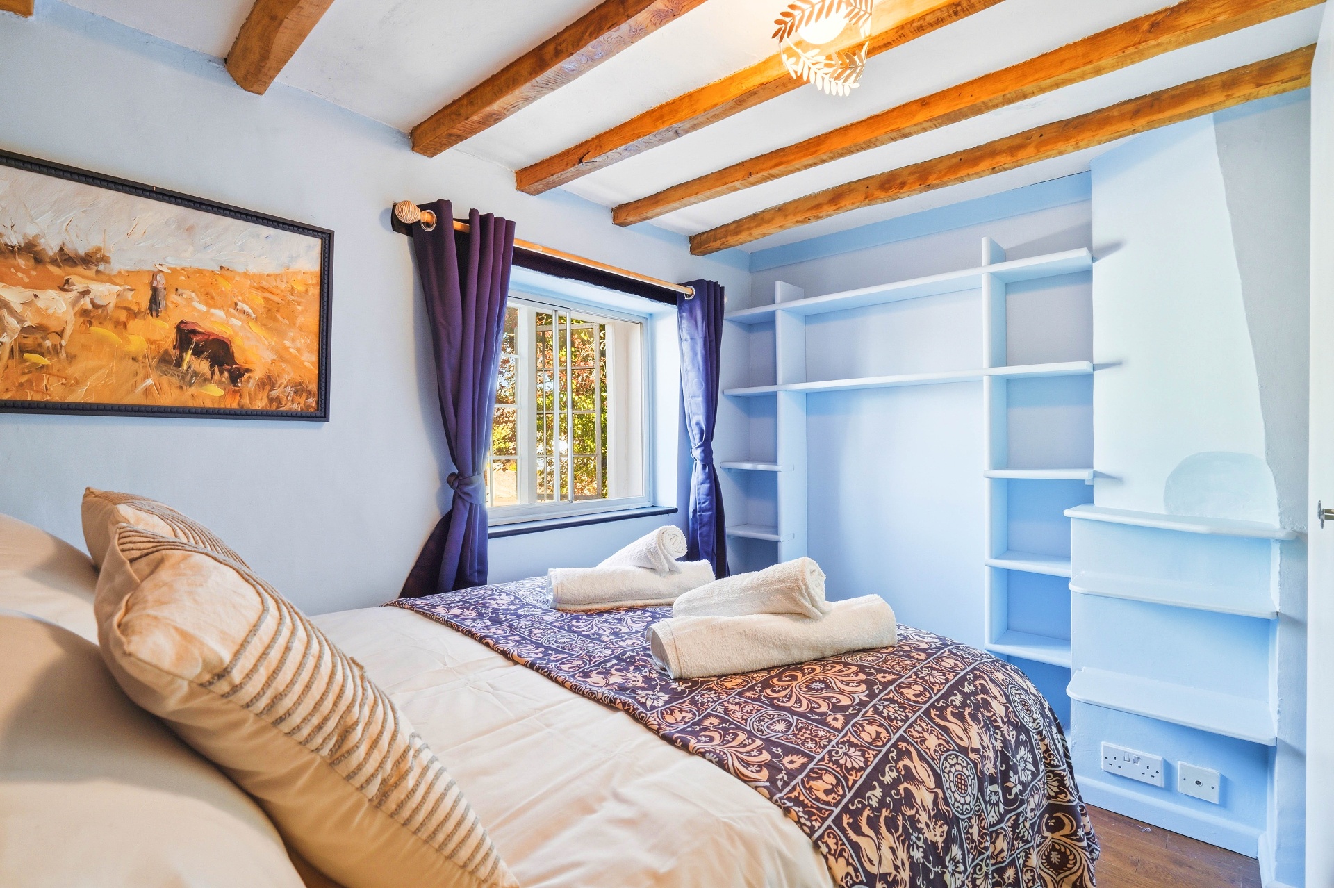 Bedroom Four showing the built-in shelving wall and workspace nook