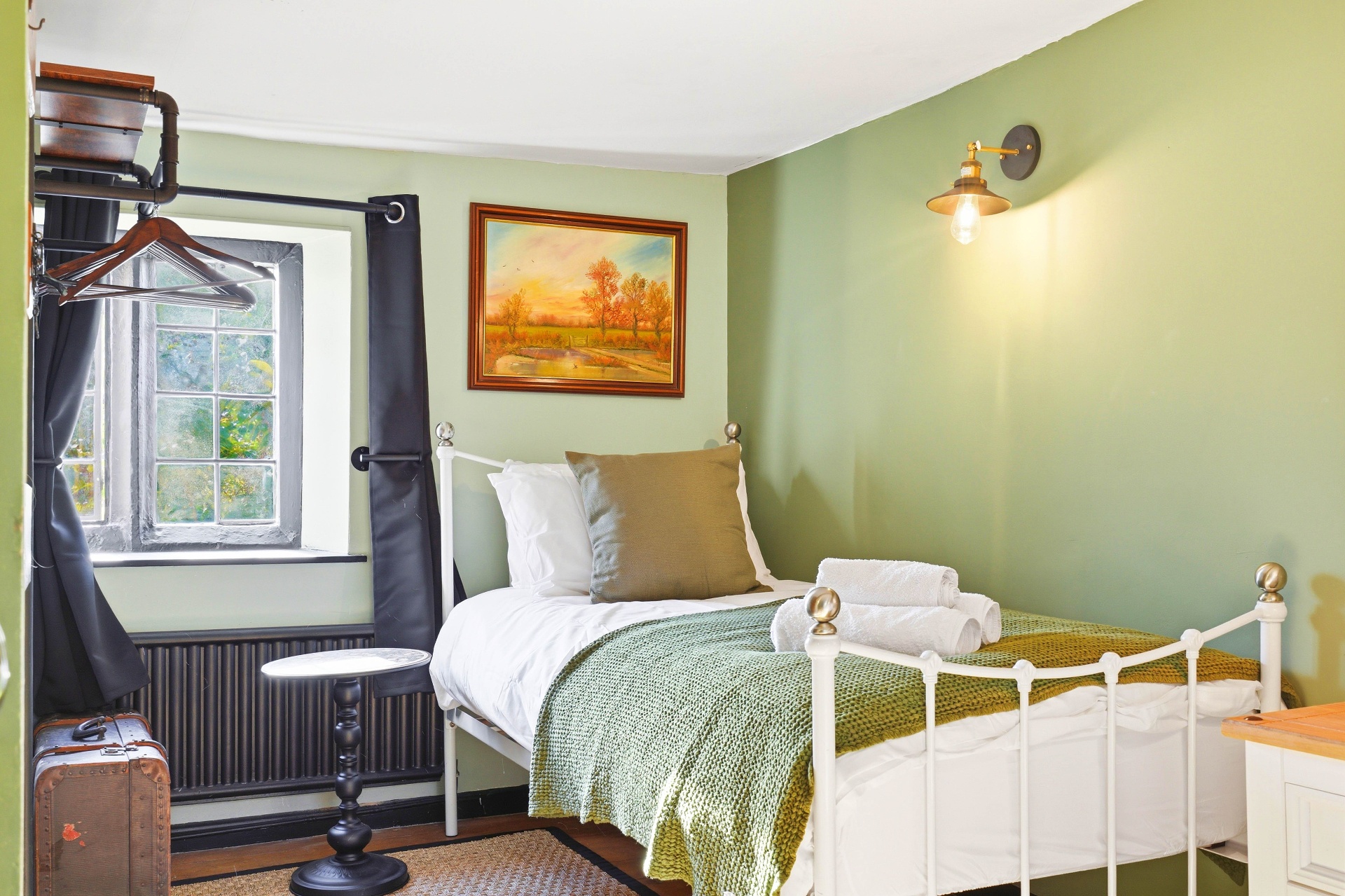 Bedroom Two single bed beside a cottage window