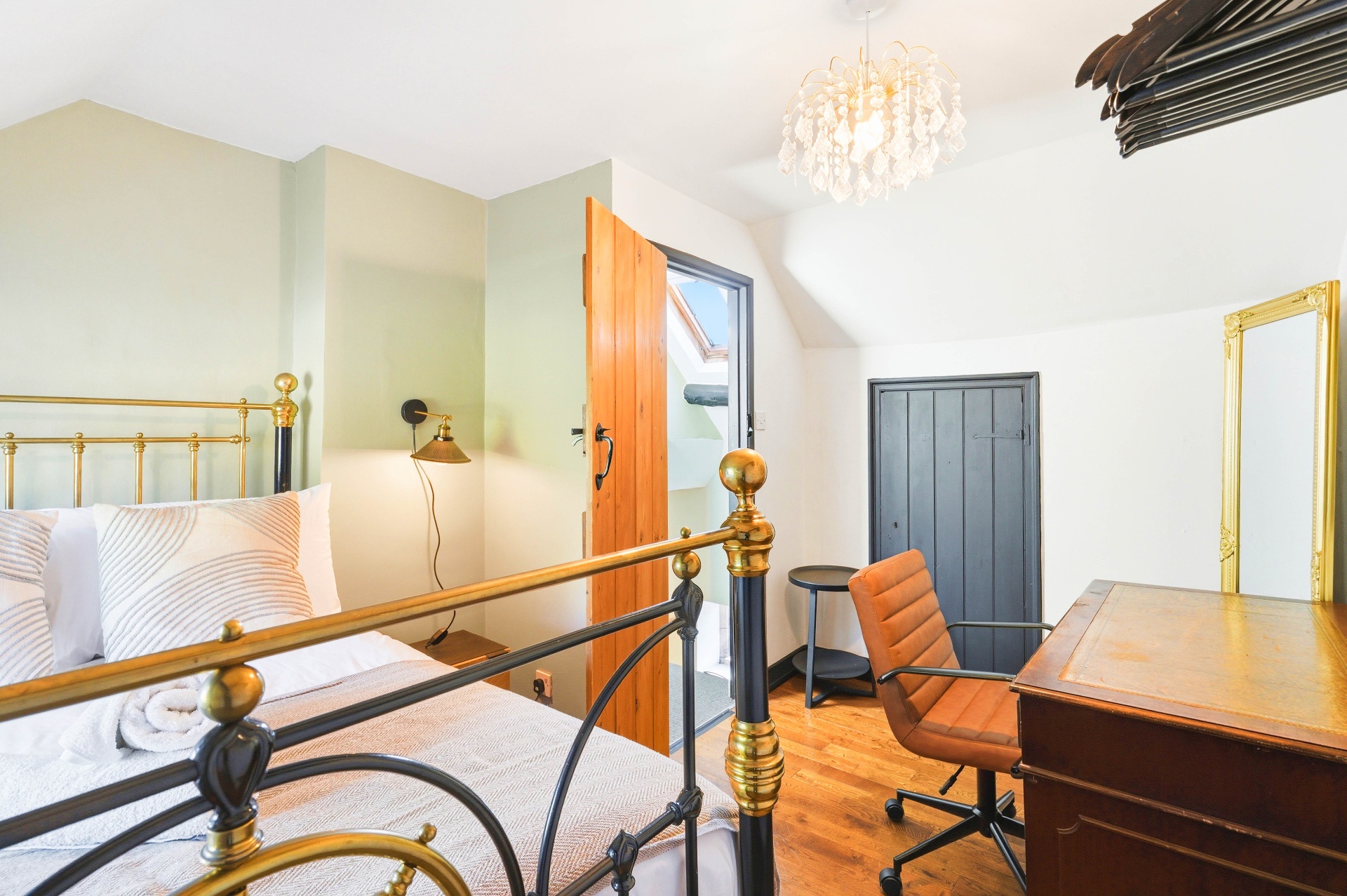 Bedroom One wide view with desk and antique map artwork