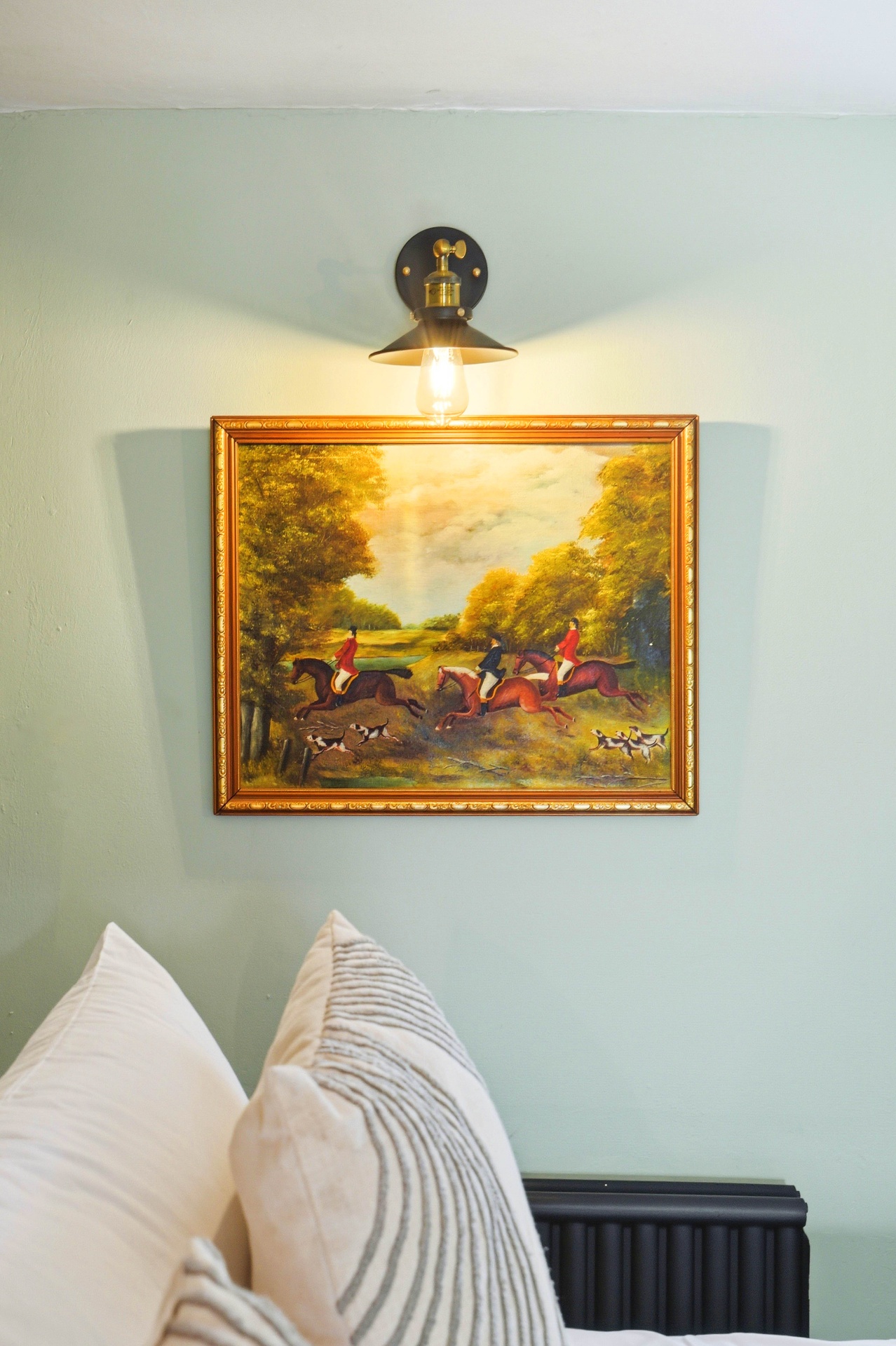 Framed equestrian painting above the bed in Bedroom Two