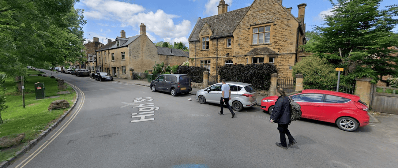 Cars parked along the High Street kerb in Moreton-in-Marsh.